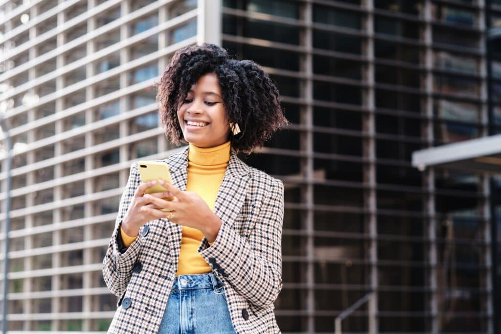 Business woman using her phone outdoors.