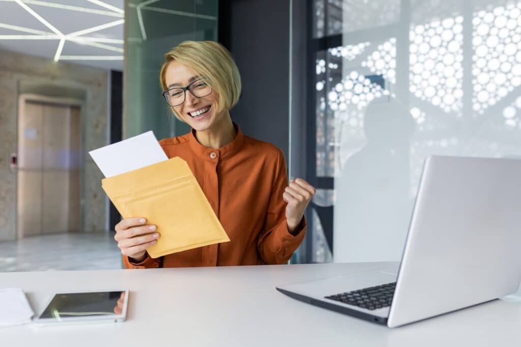 Woman received a happy letter from the bank, businesswoman reads and rejoices celebrating success