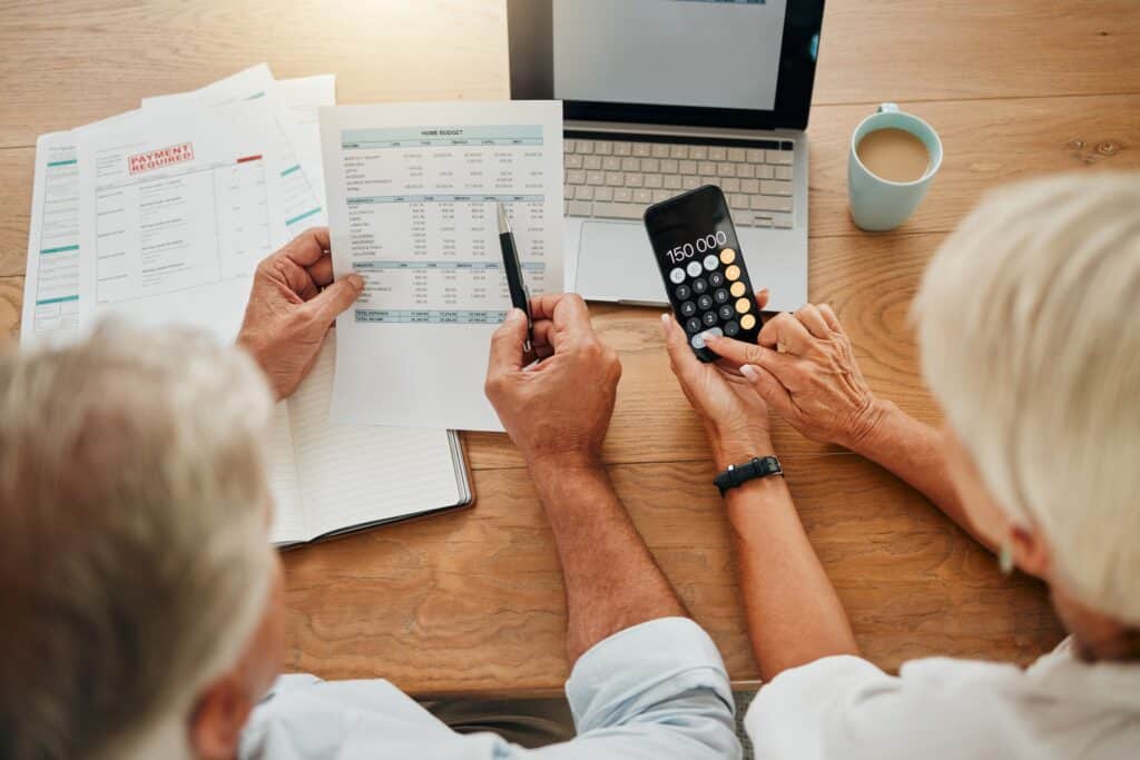 Home budget, finance planning and senior couple calculating their expenses, bills or income during