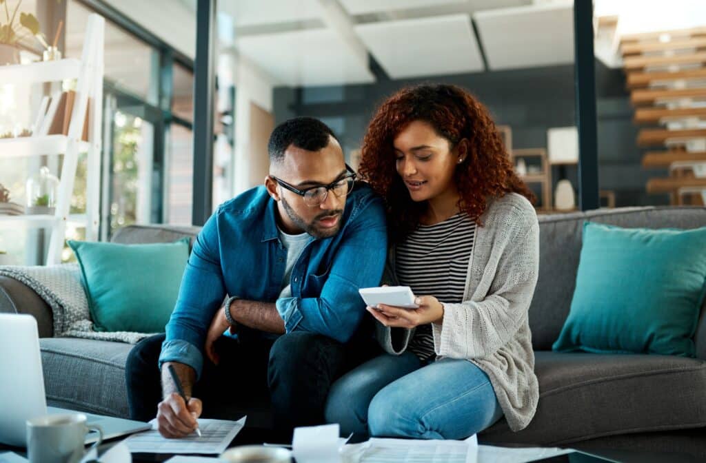 Shot of a young couple planning their budget together at home