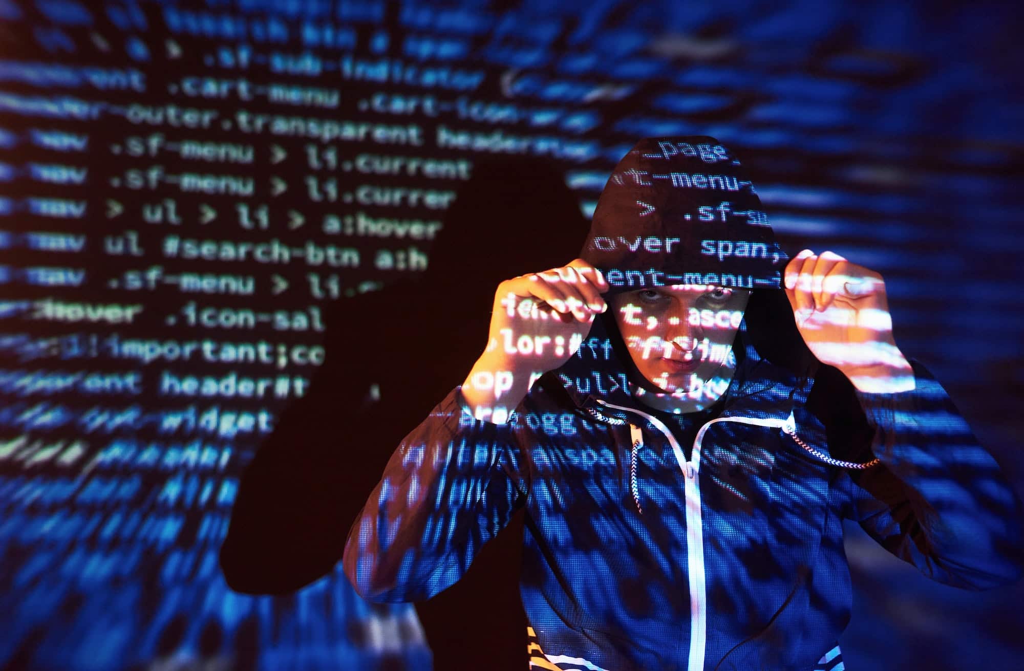 Cyber attack with unrecognizable hooded hacker using virtual reality, digital glitch effect